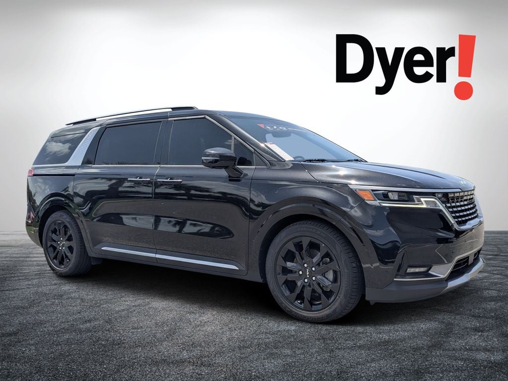 2024 Kia Carnival SX in Aurora Black Pearl — front three-quarter view